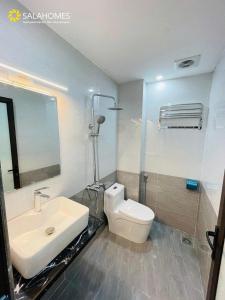 a bathroom with a toilet and a sink at Salahomes Apartment by Dapano in Hanoi +29 photos