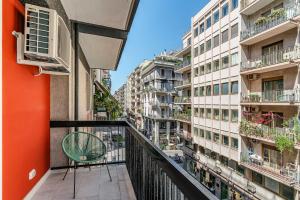 a balcony with a chair and some buildings at Puglialux in Bari