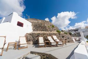 a group of chairs on the roof of a building at Gemini Cave Florina in Oia