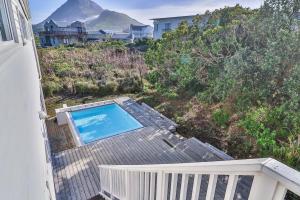 an overhead view of a swimming pool on a deck at Nordic Family Beach House in Bettyʼs Bay