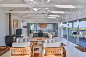 a living room with a couch and a table at Nordic Family Beach House in Bettyʼs Bay