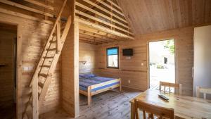 a log cabin with a bed and a staircase at O.W.Cynamon in Dziwnów