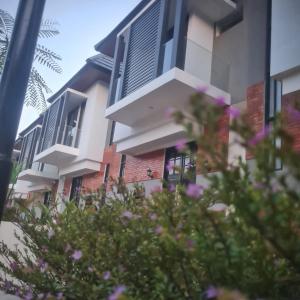 a building with purple flowers in front of it at Sabrina Sweet Villa Batu walking distance Jatim Park 2 in Batu