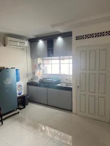 een keuken met een witte deur en een wastafel bij Giggsy Homestay at Belakang Balok in Bukittinggi