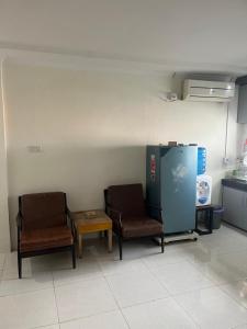 twee stoelen en een tafel in een kamer bij Giggsy Homestay at Belakang Balok in Bukittinggi