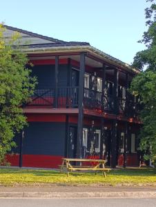 a wooden bench sitting in front of a building at Enzo Hotels Quimperle in Quimperlé