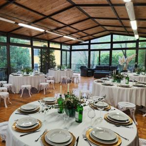 a banquet hall with white tables and chairs at I Giardini di Marcello in Dicomano