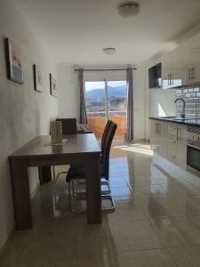 a kitchen with a table and chairs in a room at Angel House in Los Abrigos