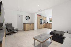 a living room with a couch and a table at The House of Foam - Agde in Agde +20 photos