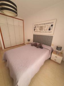 a bedroom with a bed with a teddy bear on it at Angel House in Los Abrigos +12 photos