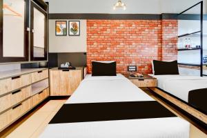 Super Townhouse Oak Mangalore客房内的一张或多张床位
