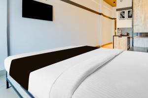 Super Townhouse Oak Mangalore客房内的一张或多张床位