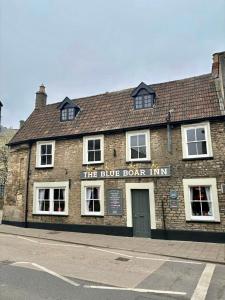 a brick building with a blue door inn on a street at Blue Boar in Frome +6 photos