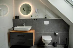 a bathroom with a sink and a toilet at Roof-Suite 03 I Aufzug I Smart-TV I Balkon I WiFi in Rheda-Wiedenbrück +6 photos