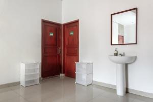 a bathroom with a sink and a mirror at Mono Coliving Benhil, Jakarta Pusat in Jakarta +20 photos