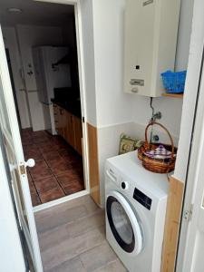 a laundry room with a washer and dryer at Casa Niebla in Vejer de la Frontera +4 photos
