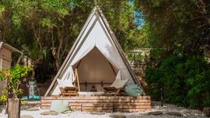 a teepee tent with chairs in a yard at TAIGA Tarifa Valdevaqueros in Tarifa
