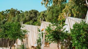 a group of tents with trees in the background at TAIGA Tarifa Valdevaqueros in Tarifa