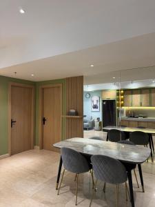 a dining room and living room with a table and chairs at Japandi Serenity 1 king,1 queen,1 single bed 5pax in Medan