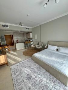 a bedroom with a large bed and a living room at Yas Island Studio Golf Escape in Abu Dhabi