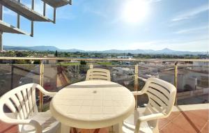 a white table and chairs on a balcony at Awesome Apartment In Bellreguard in Bellreguart