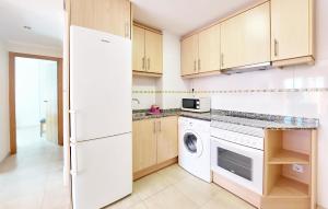 a kitchen with a white refrigerator and a dishwasher at Awesome Apartment In Bellreguard in Bellreguart