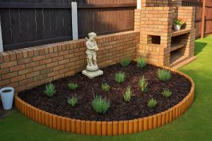 a garden with a statue in front of a brick wall at Newry Premium B&B in Newry