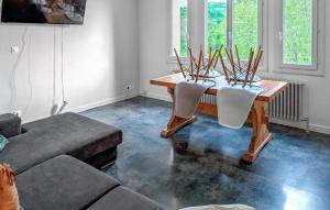 a living room with a table and two chairs at Awesome Home In Bellaffaire With Wifi in Bellaffaire