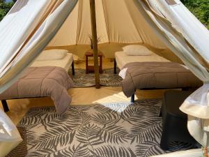 Postel nebo postele na pokoji v ubytování Camping Cap-Ouest