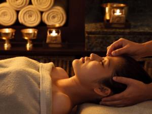 a woman getting a massage in a spa room at Baan Ping Tara Tropical Pool Villa and Scooter in Ban Khlong Son