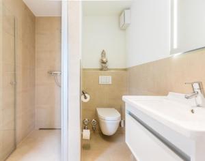 a bathroom with a white sink and a toilet at Viktoria 4 you - Whg. 05 in Westerland (Sylt) +7 photos