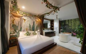 a bedroom with a large bed and a bath tub at ABC Villa Nha Trang in Nha Trang +168 photos