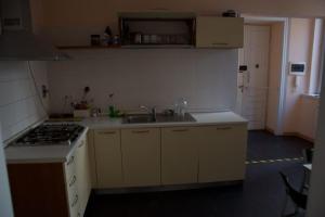 a small kitchen with a sink and a stove at Alessandro in Trieste