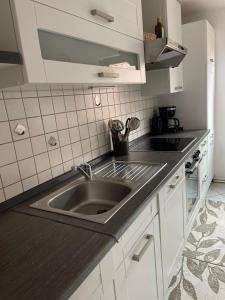 a kitchen with a sink and a counter top at Ferienwohnung Emmi in Nordenham