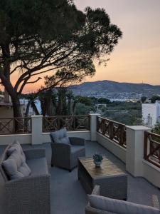 a patio with couches and a table with a view at Casa Carmela in Posidhonía
