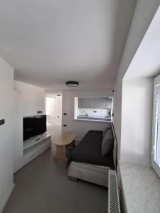 a living room with a couch and a table at Penzion Cohla - Nová Paka in Nová Paka