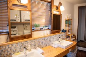 a bathroom with two sinks and a mirror at Shimanto Hutte in Shimanto-cho