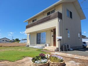 a house with two potted plants in front of it at Peaceful Garden Home in Ota, Entire 3BR Parking in Ota +41 photos