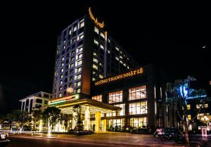 a large building with lights on it at night at Muong Thanh Luxury Nhat Le Hotel in Dong Hoi