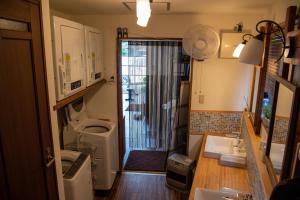 a small kitchen with a sink and a toilet at Shimanto Hutte in Shimanto-cho