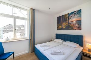 Un pat sau paturi într-o cameră la Ferienwohnung Schilfrohr Meerblick Kamin Sauna +20 fotografii