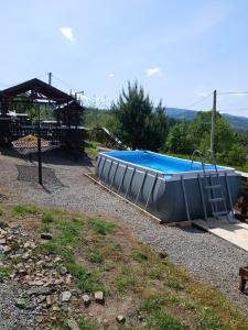 a swimming pool with a gazebo next to at Гірська вершина in Slavske