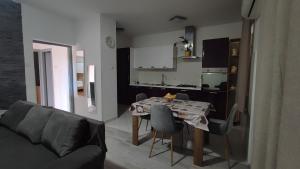 a living room with a table and a kitchen at Laura in Koromačno