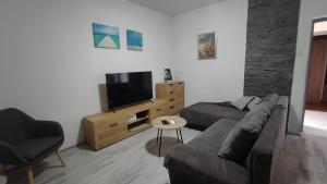 a living room with a couch and a television at Laura in Koromačno
