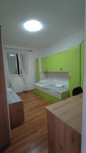 a room with two beds with green walls at Laura in Koromačno