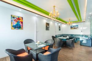 a restaurant with tables and chairs and a chandelier at Hotel Sapana Garden Thamel in Kathmandu