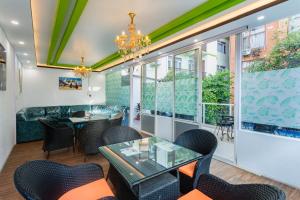 a dining room with a table and chairs and windows at Hotel Sapana Garden Thamel in Kathmandu