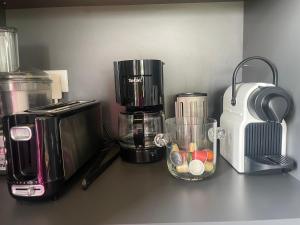 a counter top with a coffee maker and a blender at Villa 7 in Martillac