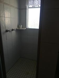 a bathroom with a tiled shower with a window at The Ladi B&B in Ladismith +4 photos