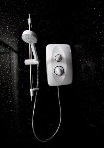 a white hair dryer hanging on a wall at Whiteley Mill in Stapleford